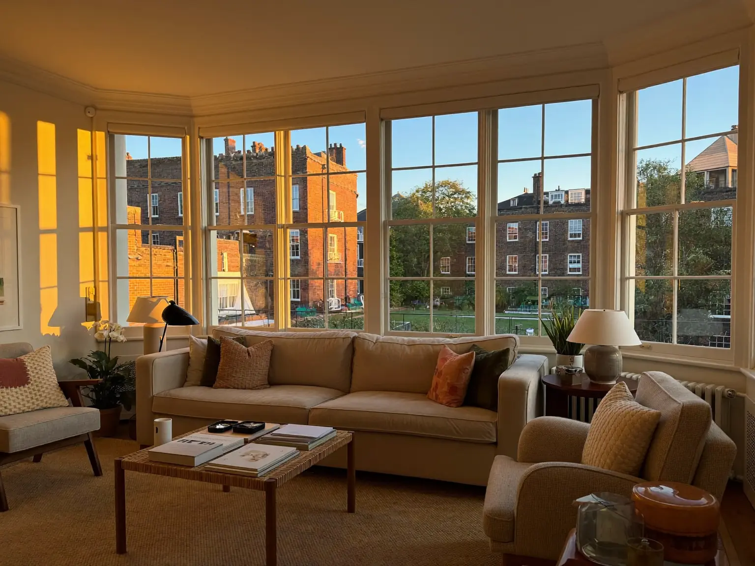 A cosy lounge in warm evening light with newly upgraded windows