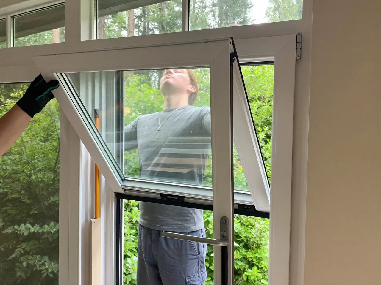 An installer fitting a window with a secure multi-point locking system